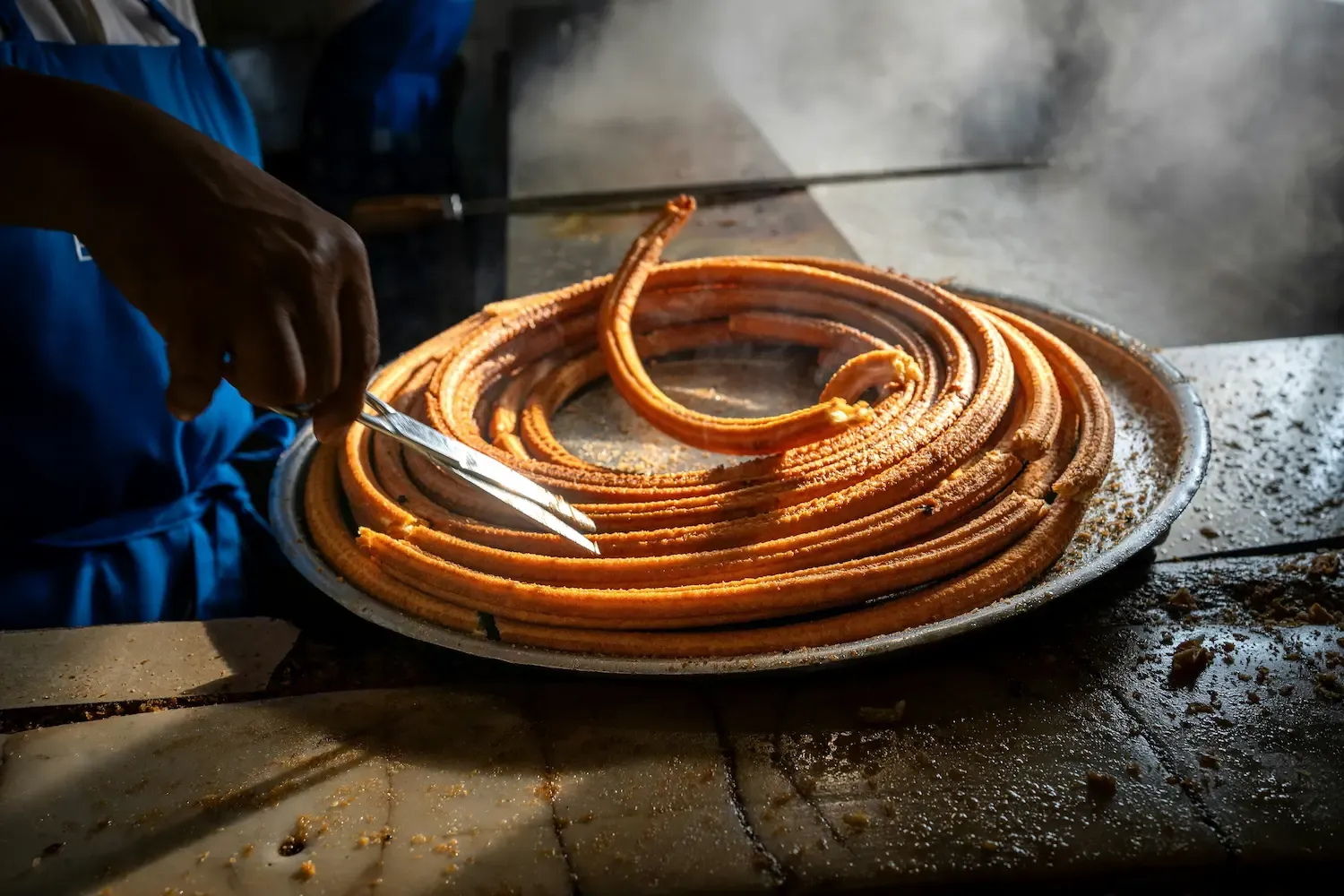 Churros Recién Hechos — Hand-piped churros fried to order, rolled in canela sugar.