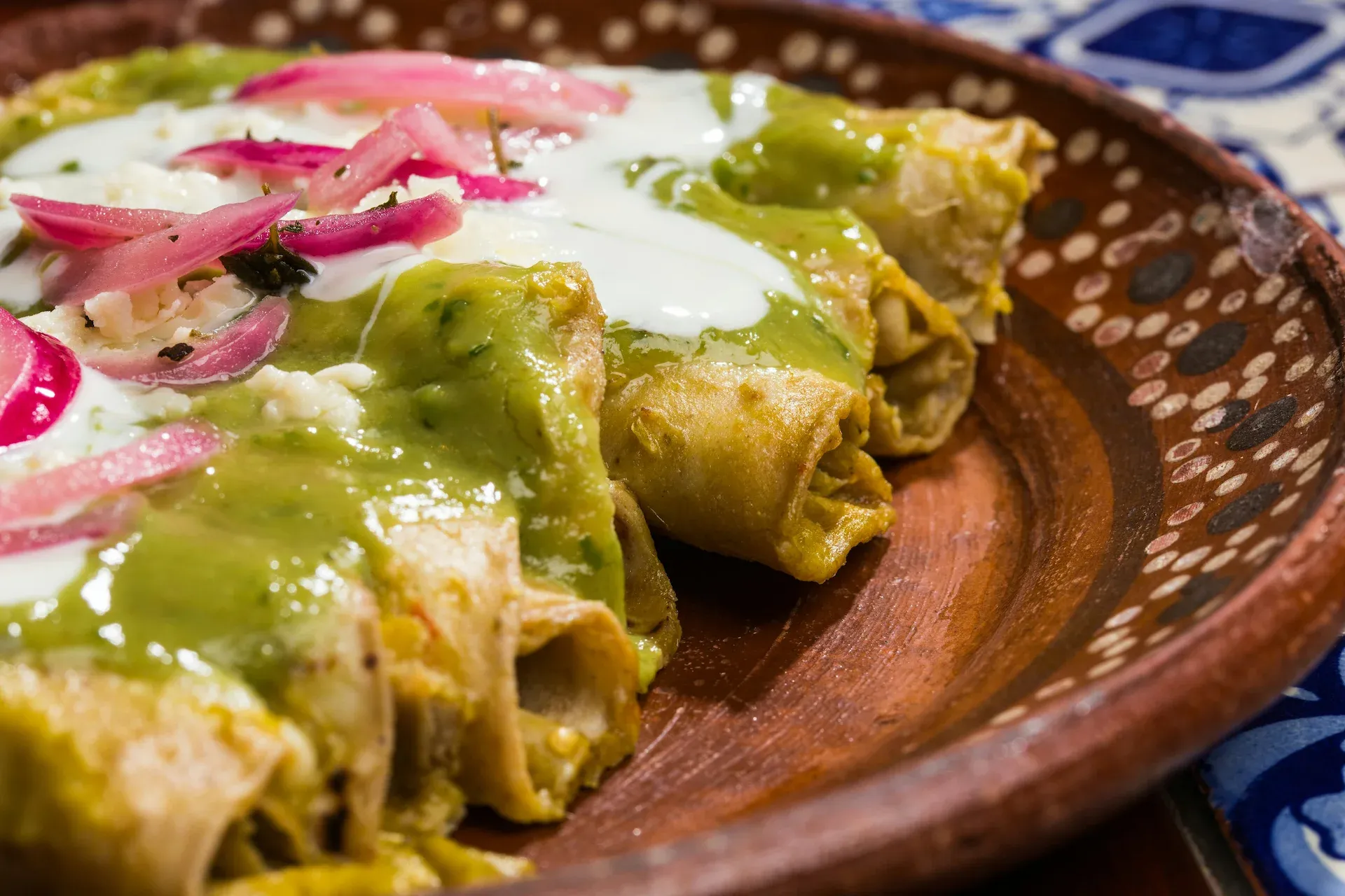 Flautas en Salsa Verde — Crispy rolled flautas, salsa verde, crema, queso fresco.