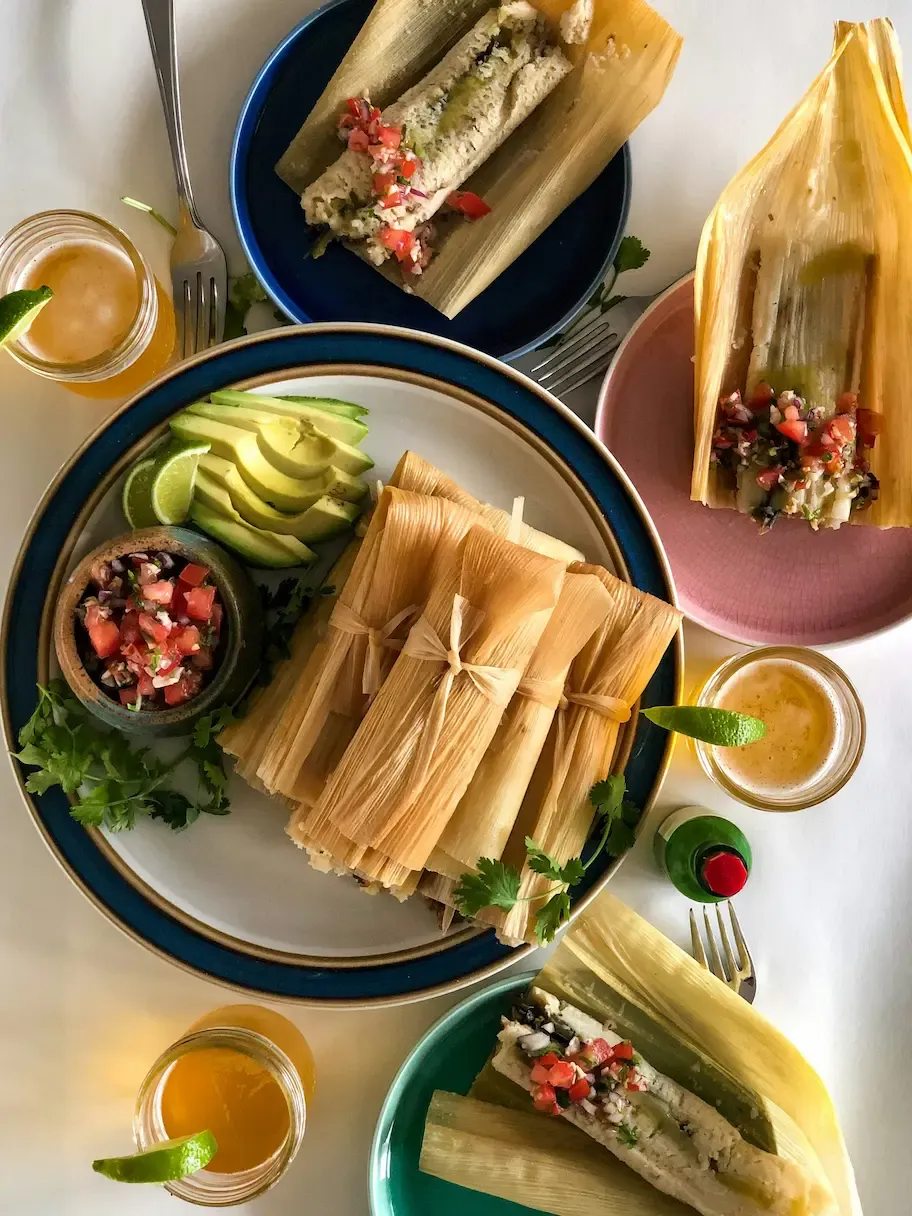 Tamales de la Casa — Trio of verde, rojo, and rajas tamales, hoja de maíz, pico de gallo.